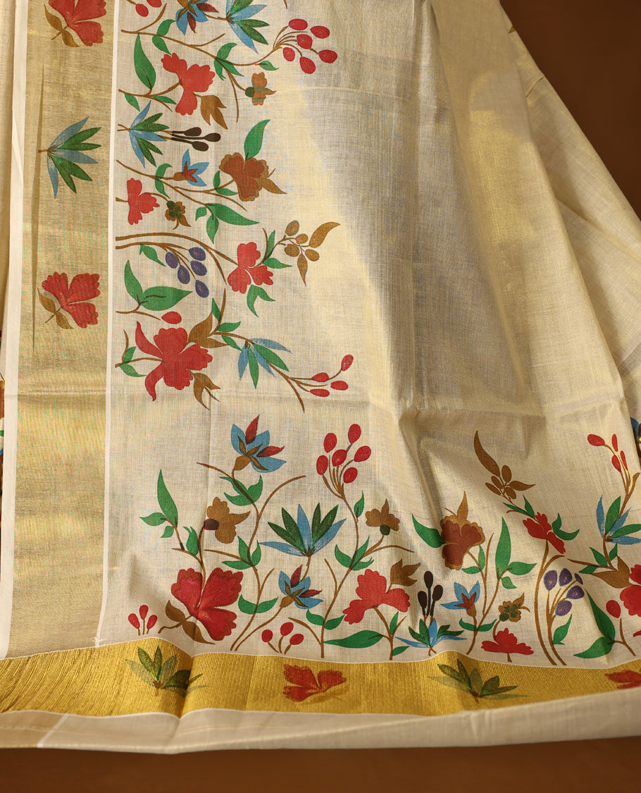 Elegent Off white colour cotton Kerala saree featuring vibrant multicolor floral prints all over the body, beautifully highlighted with a rich golden zari border paired with matching blouse.