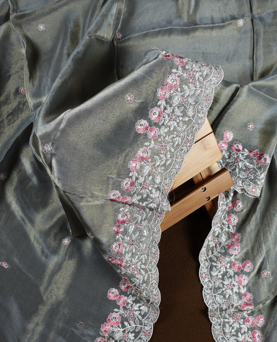 Grey colour churidar material adorned with delicate floral thread embroidery in white and pink, paired with a plain matching bottom and embroidered dupatta, perfect for festive occasions and celebrations.