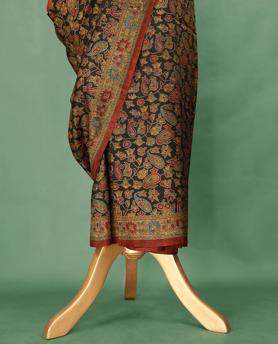 Dark colour Manipuri saree features a body filled with vibrant paisley and floral block motifs, accentuated by a multicolour floral printed border and paired with a matching blouse.