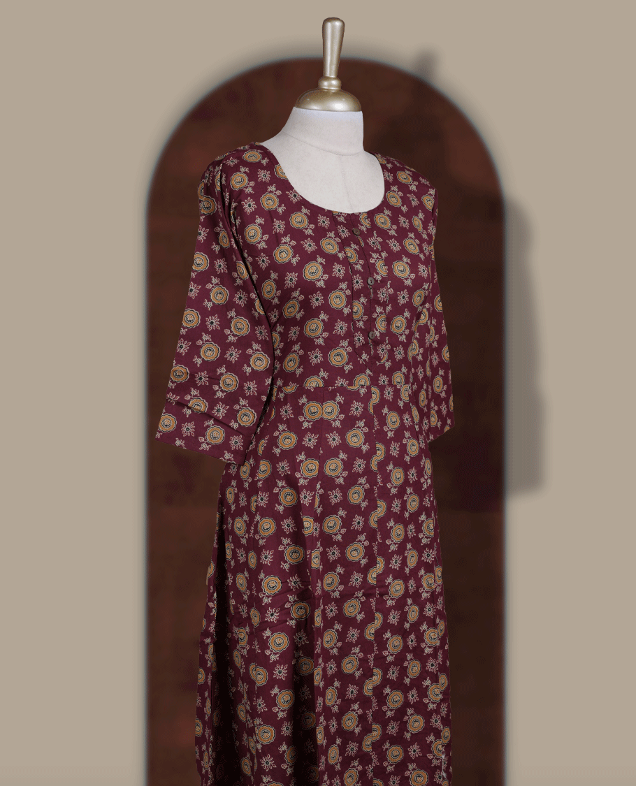 Grape colour kurthi adorned with  floral prints, featuring a classic round neckline with front buttons and comfy 3/4th sleeves.