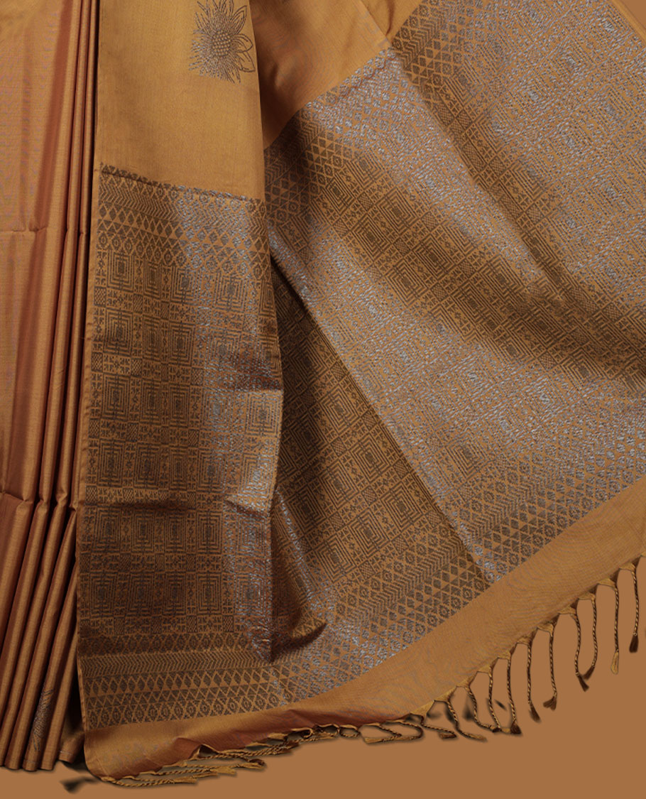 Dark Mustard colour semi soft silk saree adorned with delicate woven floral motifs on the body, complemented by a Self colour woven pallu with intricate detailing and tassel accents without border & Comes with a matching blouse piece.