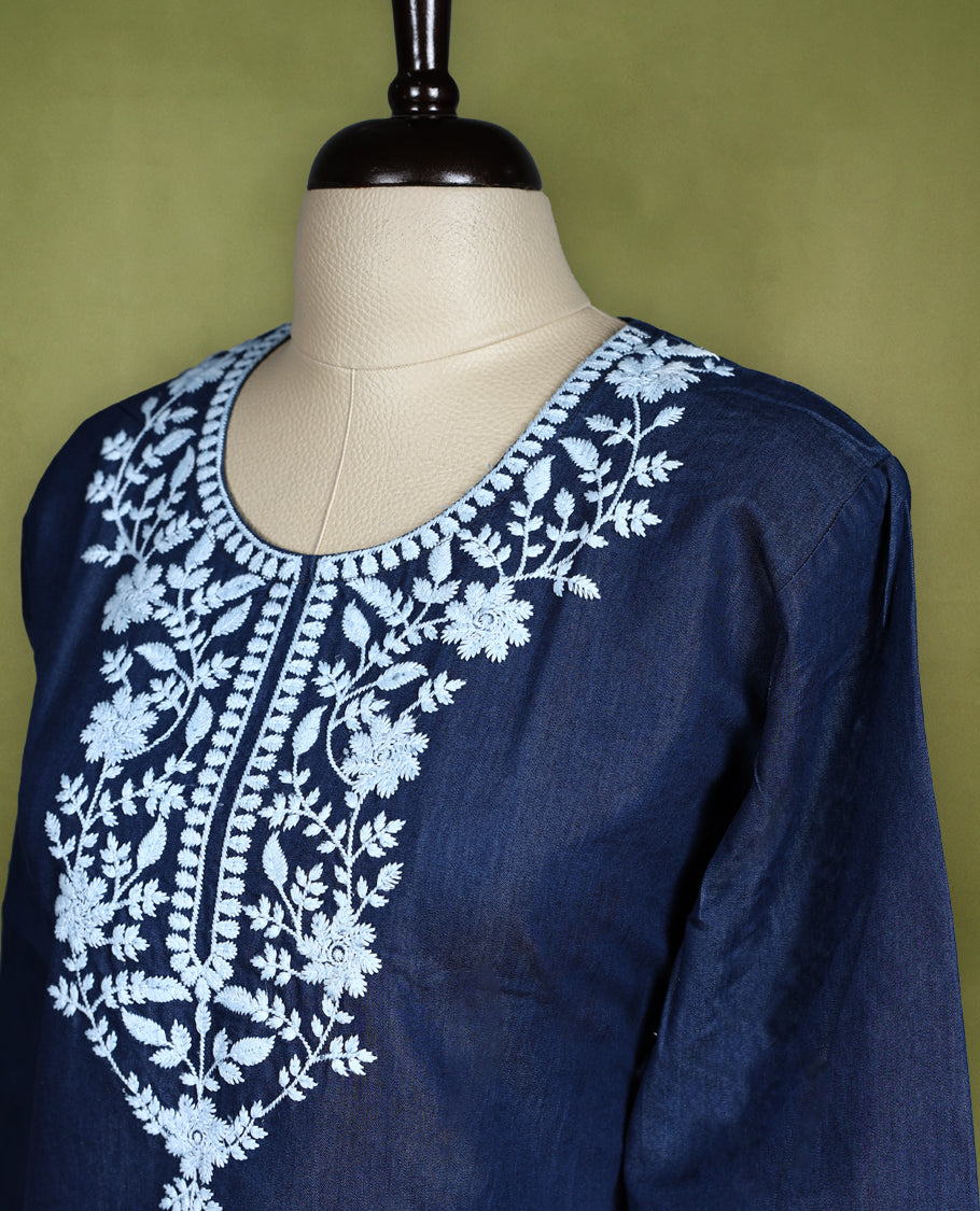 Deep navy blue colour kurti featuring intricate white floral thread embroidery on the yoke and all over the front panel, designed with a rounded neckline and keyhole detail, paired with 3/4th sleeves and straight hemline
