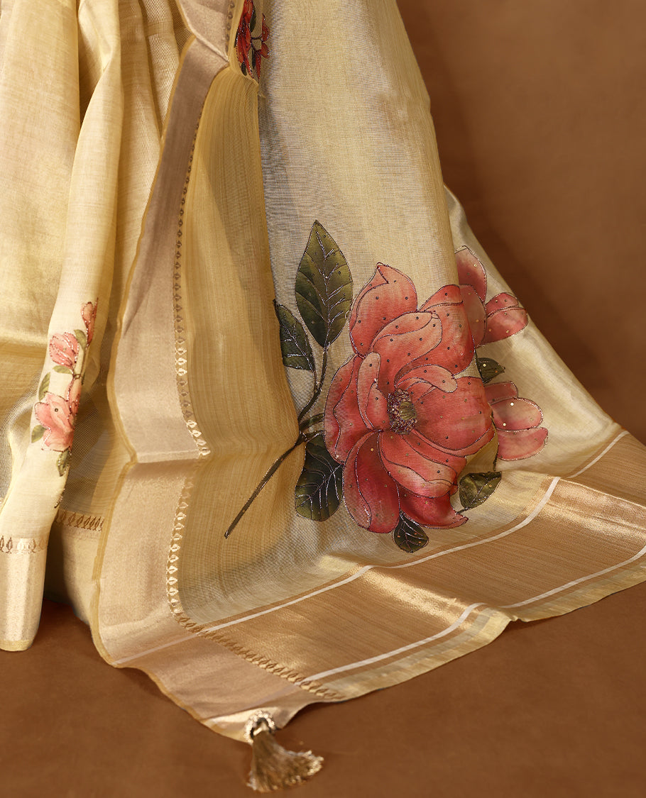 Light gold colour Organza Kerala saree with a sheer, smooth body and soft golden sheen. Accented with a fine zari border and subtle floral motifs near the pleats, Comes paired with a coordinated matching blouse.