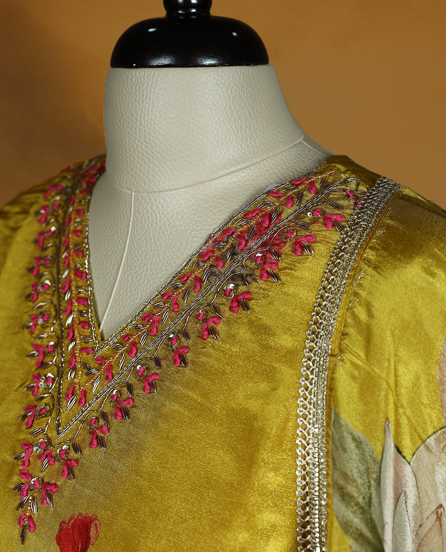 Mustard yellow colour salwar from TWARA, featuring a V-neck adorned with cut beads, sequins, and thread work, with digital floral prints on the top, paired with a matching bottom and a digital printed dupatta.