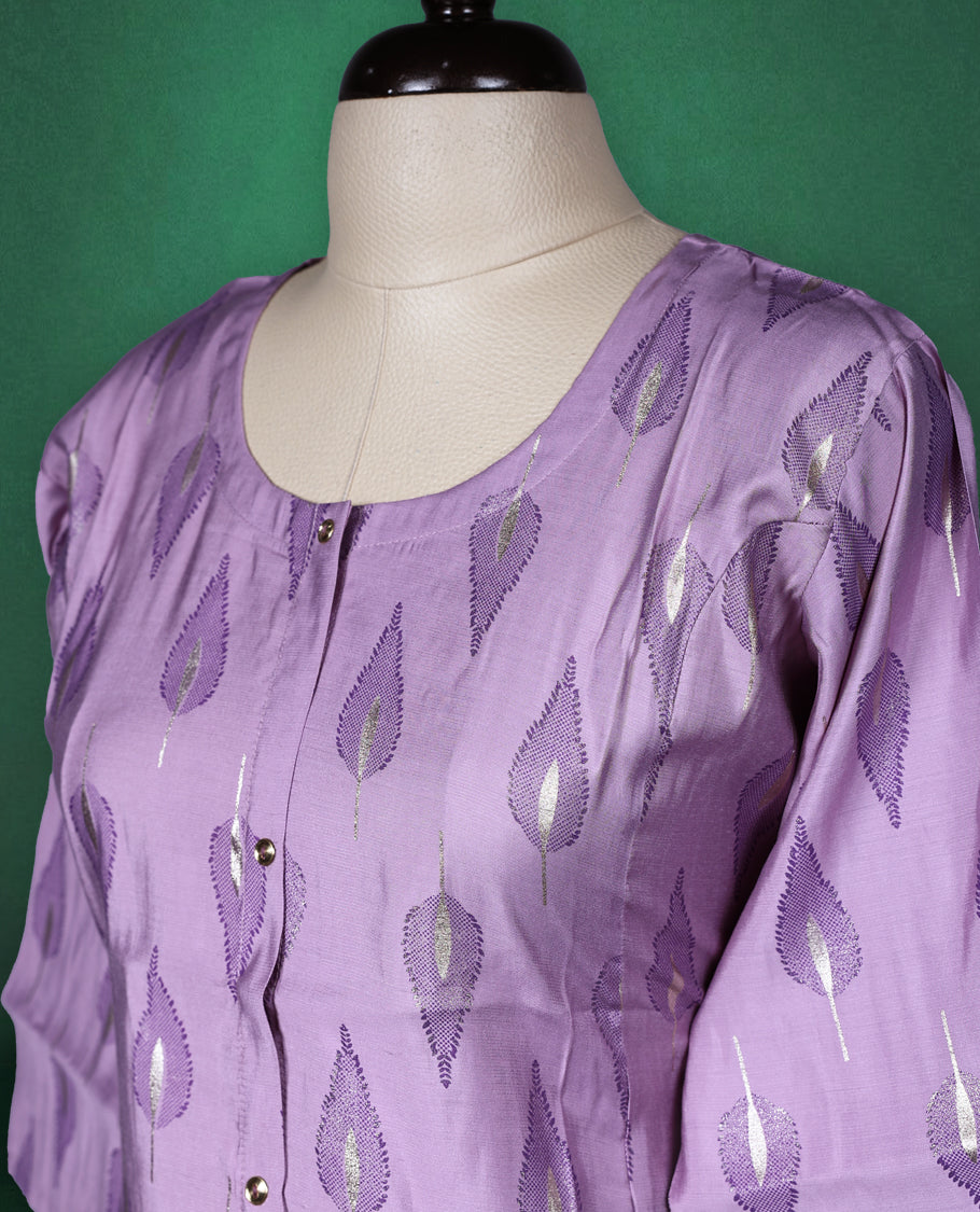 Lavender colour cotton kurti adorned with metallic silver leaf motifs, featuring a round neckline, front button placket, and elbow length sleeves a perfect blend of subtle shine and everyday comfort.