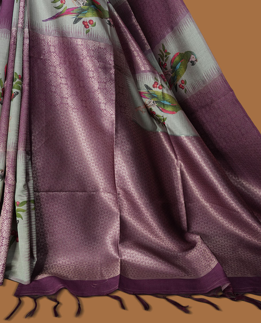 Purple Colour semi tussar Banarasi saree featuring vibrant multi-color floral prints across the body, with shimmering geometric zari patterns, and a matching blouse detailed with silver woven buttas.