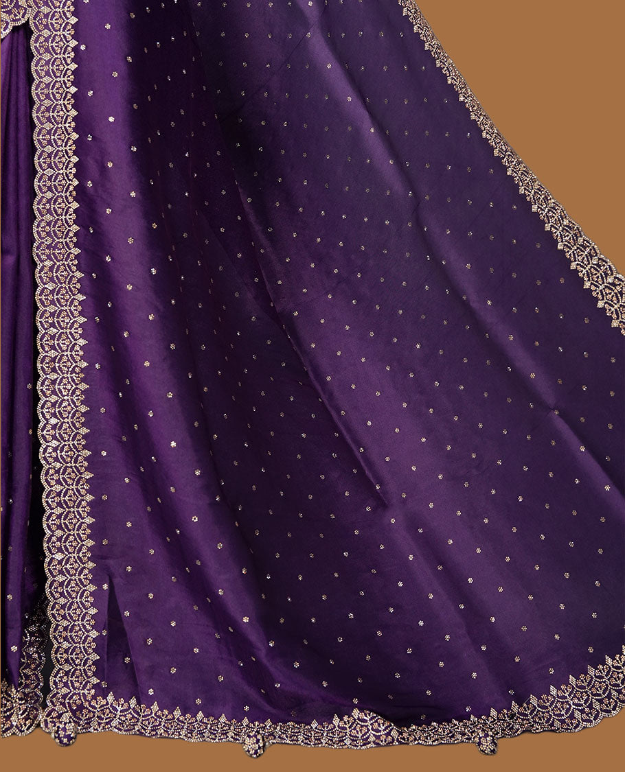 Dark Purple Colour net shimmer fancy saree adorned with scattered white stone buttas all over the body, paired with a delicate stone worked border and matching blouse featuring floral vine stone embroidery (Copy)