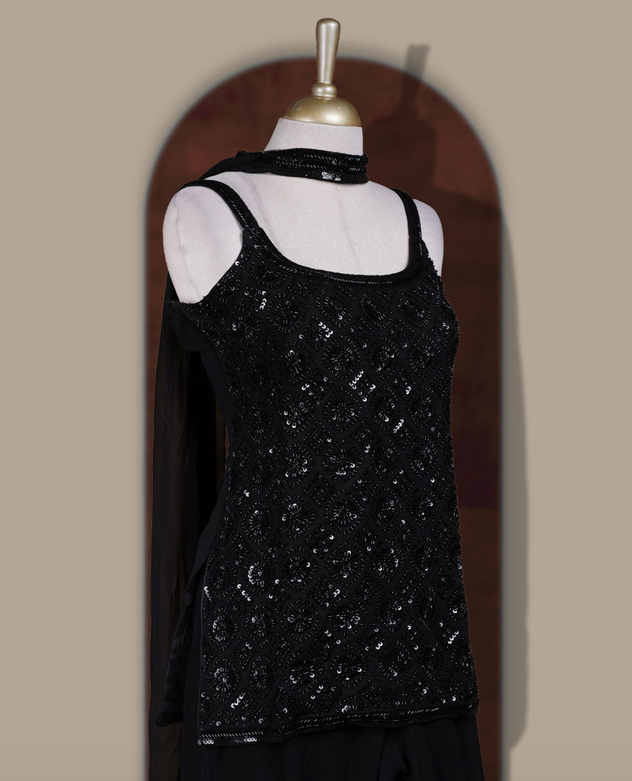 Vibrant Black colour sharara set featuring a sleeveless sequin embellished top with delicate beadwork, paired with a flowy flared bottom and dupatta for a contemporary festive look.