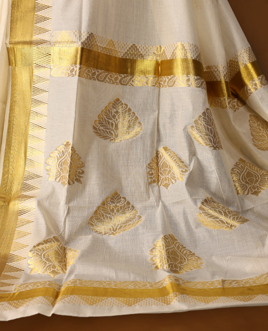 Elegant off white colour cotton Kerala saree featuring Gold zari Bold motifs on body, traditional golden zari kasavu border & Rich Pallu offering a classic and graceful look, paired with a matching blouse.