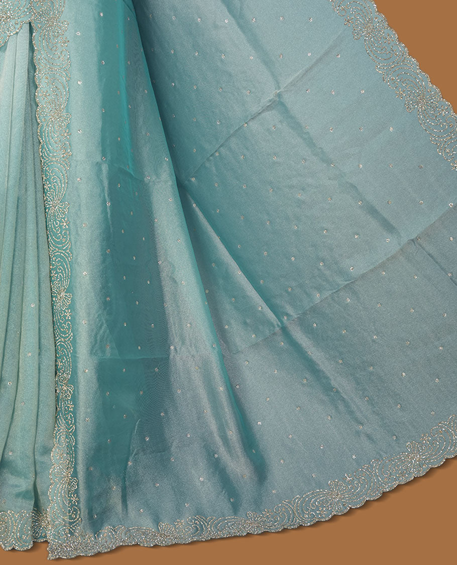 Pastel aqua blue  Colour net shimmer fancy saree adorned with scattered white stone buttas all over the body, paired with a delicate stone worked border and matching blouse featuring floral vine stone embroidery.