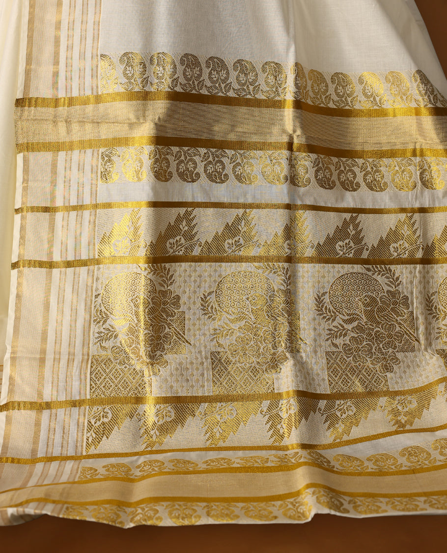 Elegant Off white colour cotton Kerala saree featuring Plain body, Gold zari fancy kazavu border, Rich Pallu paired with matching blouse.