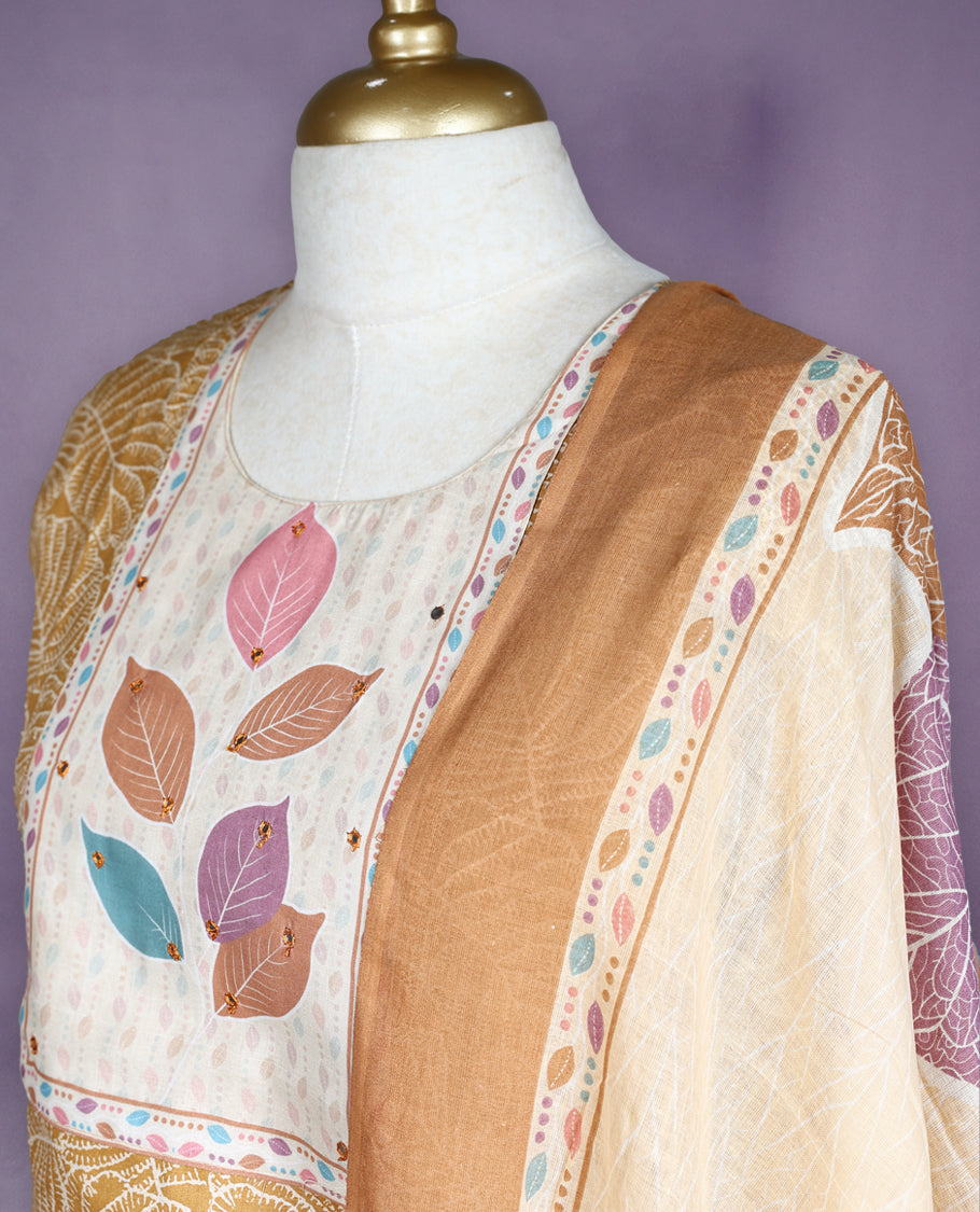 Mustard and beige colour salwar set with round neck and elbow sleeves features leaf printed yoke and all over line floral design paired with matching plain bottom and multicolour leaf print dupatta