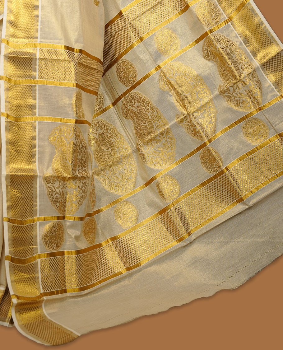 Light gold tissue Kerala saree featuring a softly shimmering body with delicate gold zari buttas, a refined kasavu border, and an intricately woven traditional pallu, paired with a matching blouse.