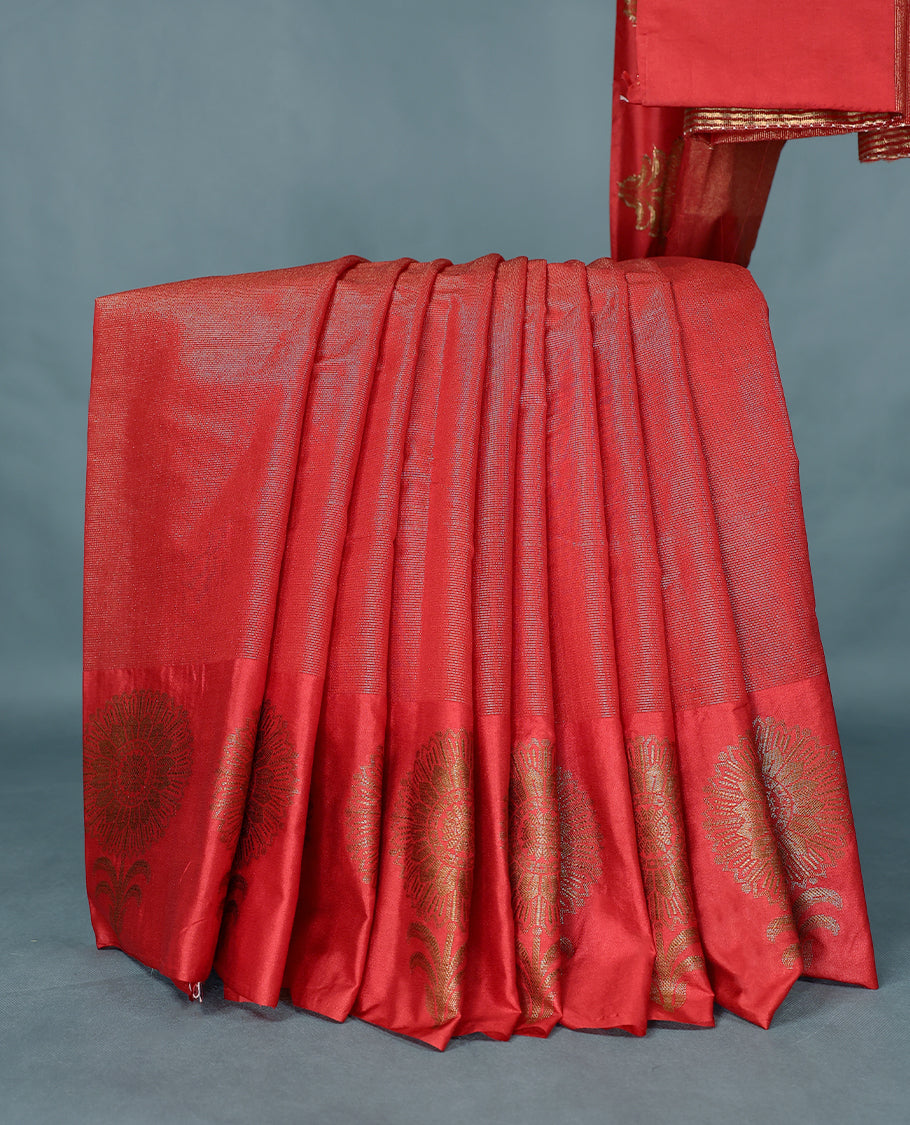 Red Colour Semi Tussar Silk saree featuring golden zari horizontal lines across the body, adorned with bold Floral motifs on the border, paired with a matching blouse.