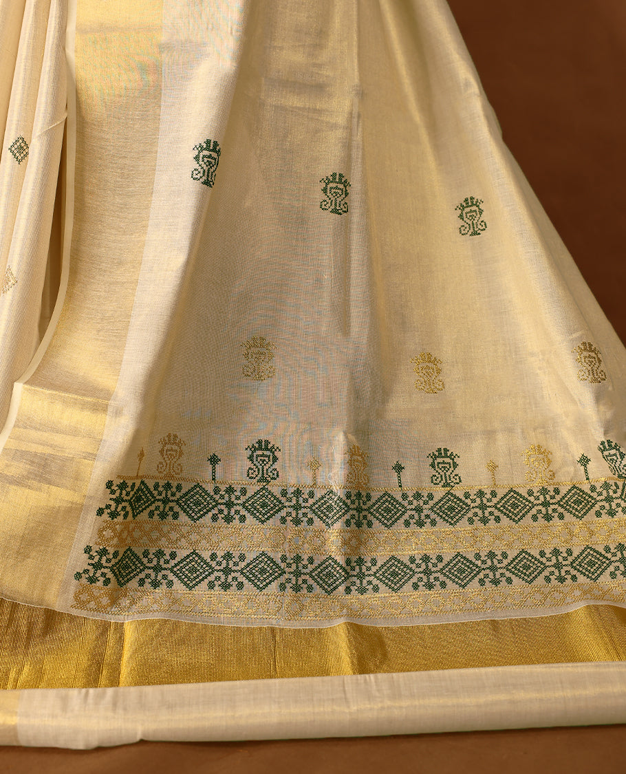 Elegant Light Gold colour Tissue Kerala saree featuring Green & gold geometric pattern embroidery worked body and traditional golden zari kasavu border offering a classic and graceful look, paired with a matching blouse.