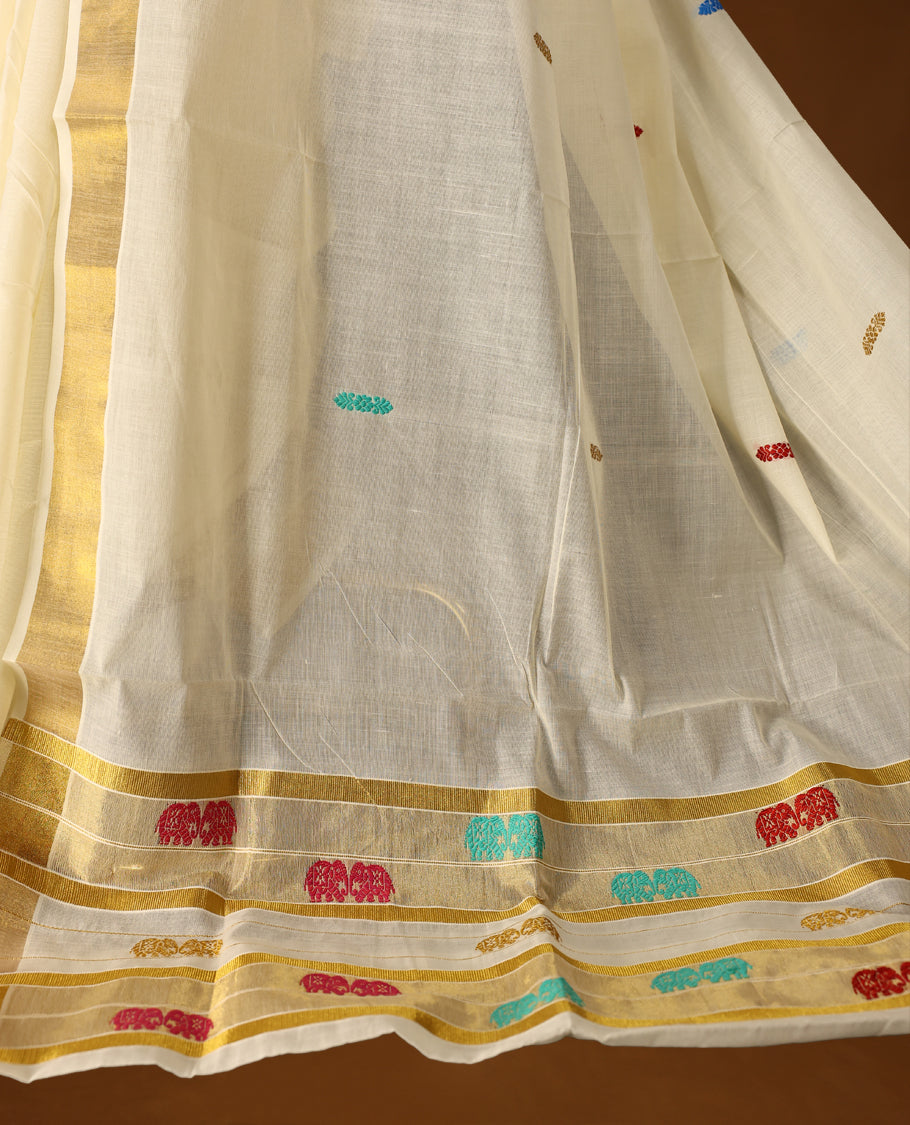 Elegant Off white colour cotton Kerala saree featuring colorful thread buttas and vibrant temple motifs on the pallu, finished with a classic golden zari border and paired with matching blouse.