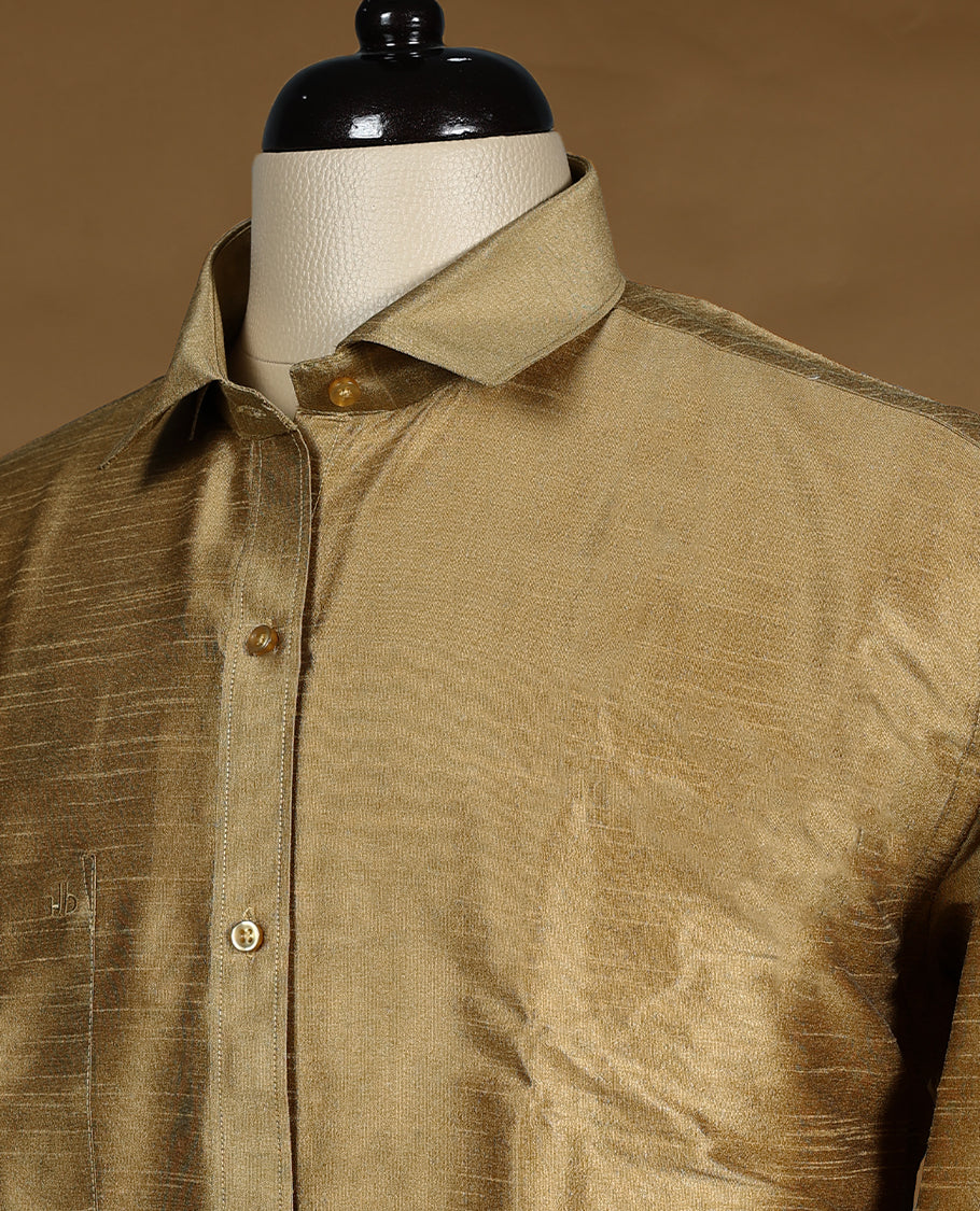 Antique Gold colour DH men’s shirt crafted in a lustrous semi silk textured fabric featuring a sleek finish, classic collar, full sleeves, and chest pocket perfect for weddings and festive occasions