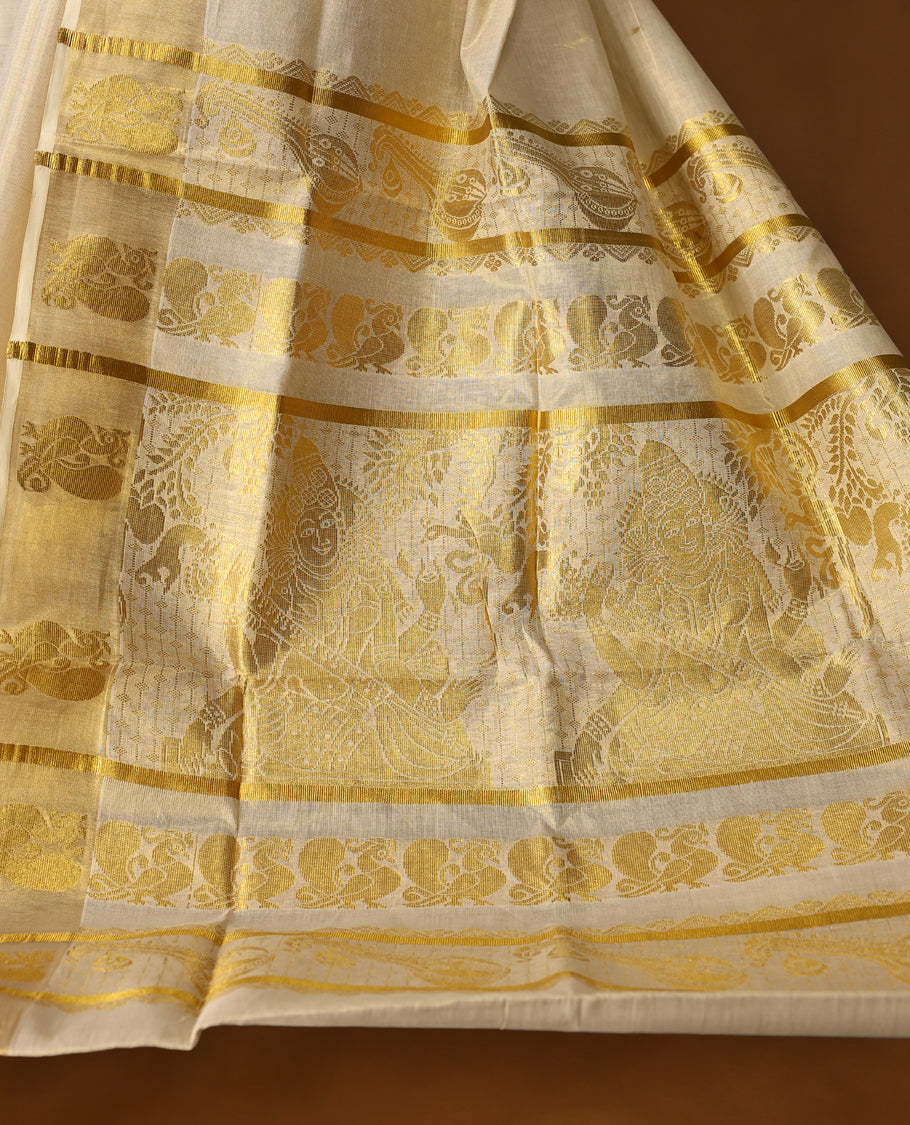 Elegant Light Gold colour Tissue Kerala saree featuring gold zari Leaf motifs on body, traditional golden zari kasavu border with peacock motifs  & Rich Pallu paired with a matching blouse.