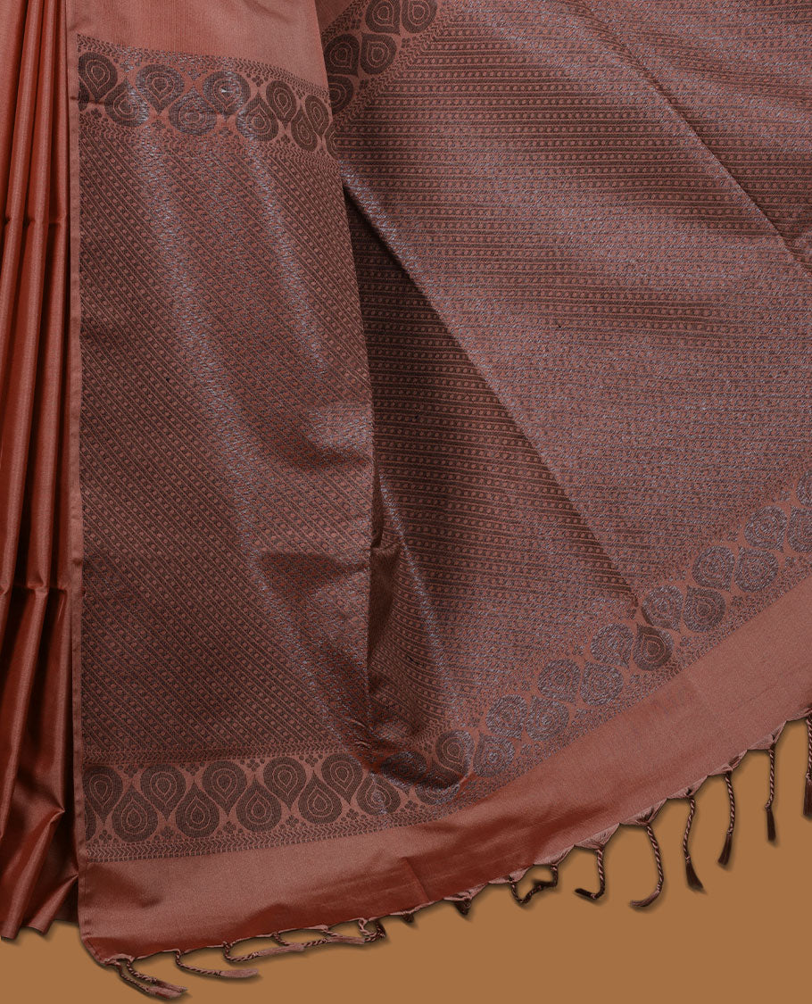 Brick colour semi soft silk saree adorned with delicate woven floral kodi motifs on the body, complemented by a Self colour woven pallu with intricate detailing and tassel accents without border & Comes with a matching blouse piece.