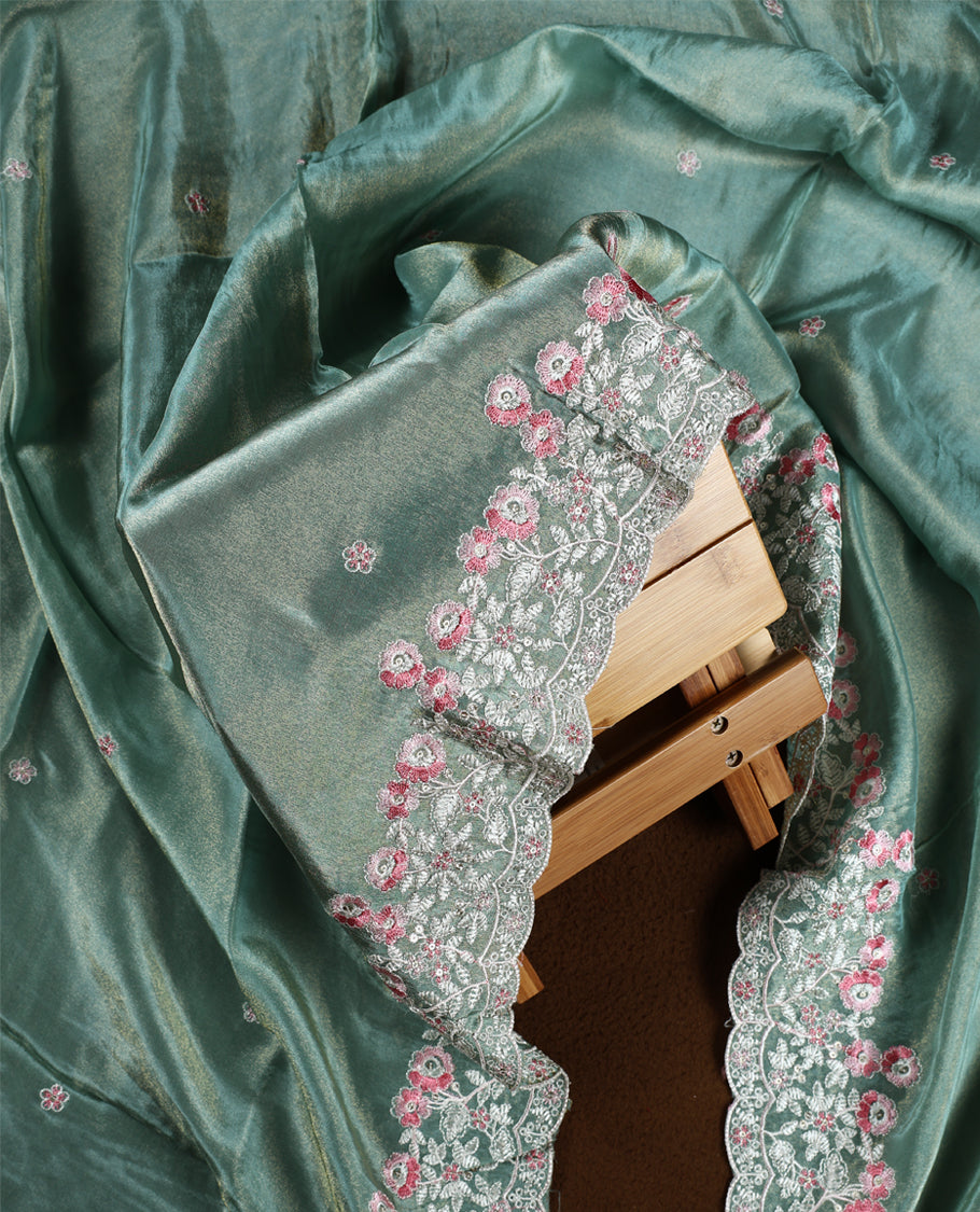 Sea green colour churidar material adorned with delicate floral thread embroidery in white and pink, paired with a plain matching bottom and embroidered dupatta, perfect for festive occasions and celebrations.