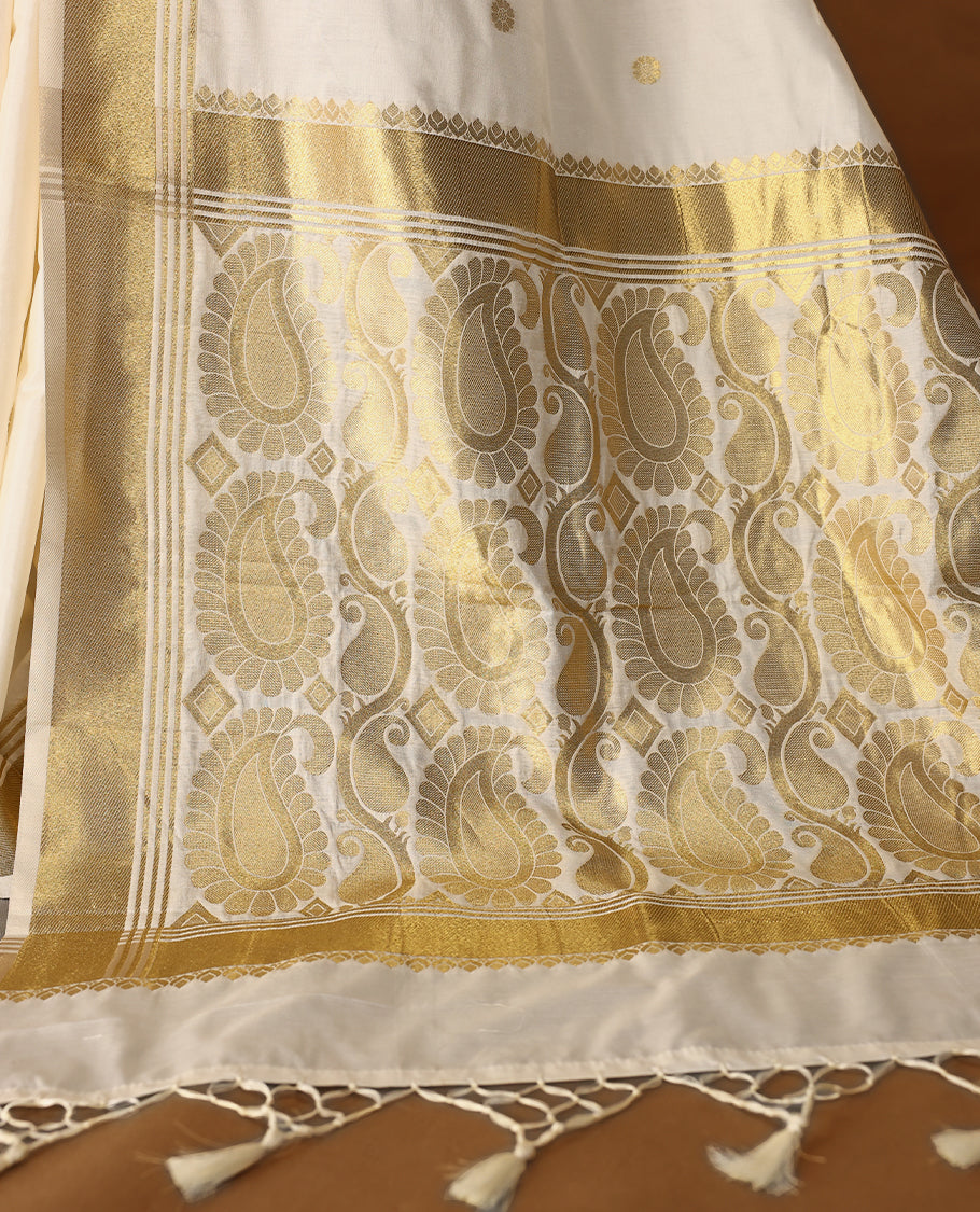Elegant white colour sotf  Tussar Kerala saree featuring Flower motifs on body, Gold kasavu border, Rich Pallu, Paired with matching blouse offering a classic and graceful look