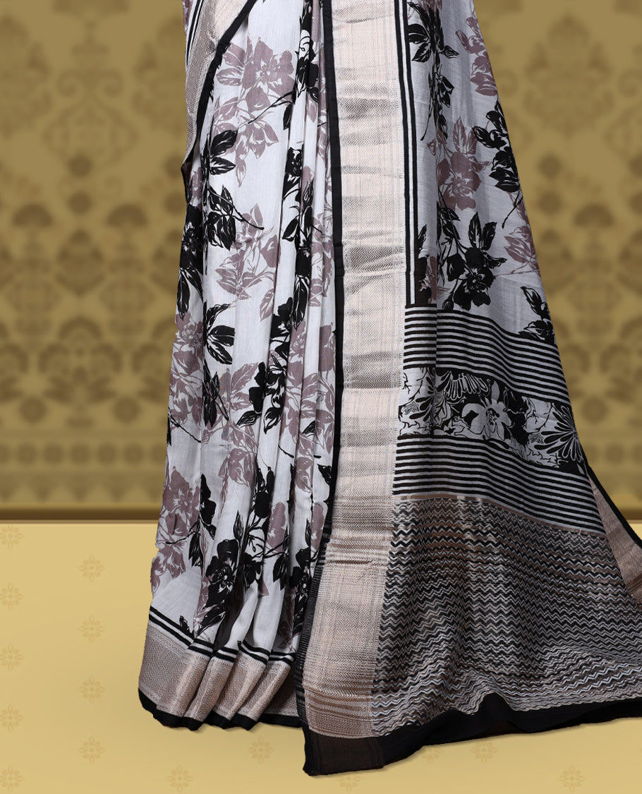 White colour saree with black and mauve floral prints, featuring a contrast zari border and detailed pallu & Comes with a matching blouse piece.