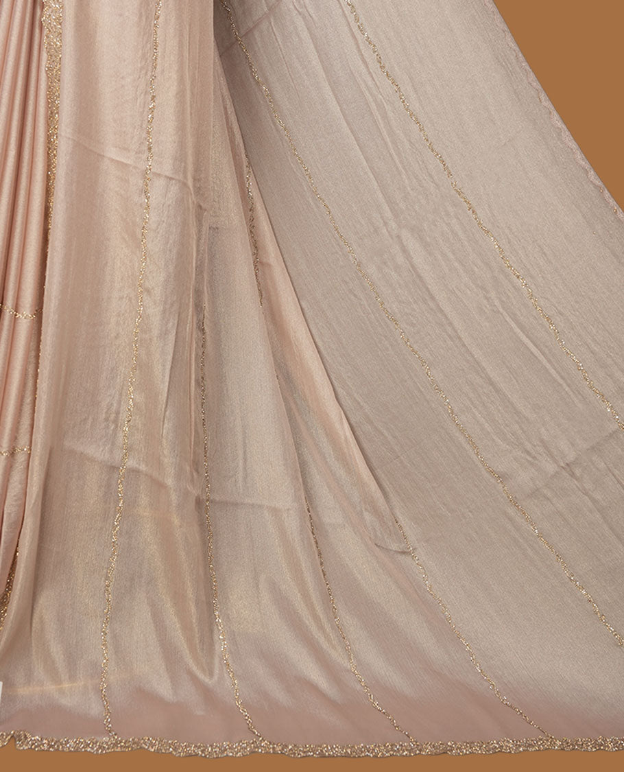 Pale pink colour net shimmer fancy saree adorned with scattered gold stone buttas all over the body, paired with a delicate stone worked border and matching blouse.