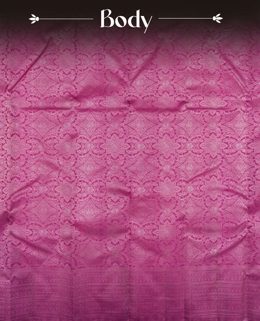 Magenta colour Kanchipuram pattern Manthrakodi saree adorned with antique copper zari floral creeper design featuring traditional peacock and elephant motifs, complemented by a rich zari jacquard border and blouse piece.