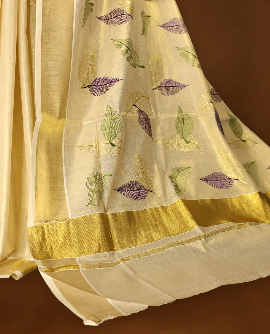 Light Gold colour Tissue Kerala saree featuring Leaves thread work on body and a beautifully woven Gold Kasavu border, paired with a matching blouse perfect for festive occasions.