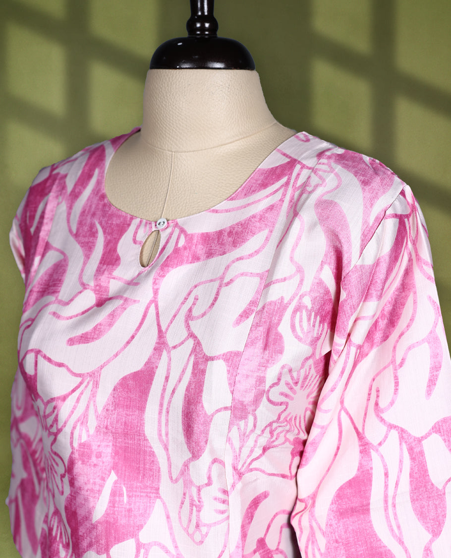 Off White and pink printed straight cut kurti featuring bold floral patterns all over, styled with a round neckline, keyhole detail, and 3/4th sleeves, perfect for a fresh and casual everyday look.