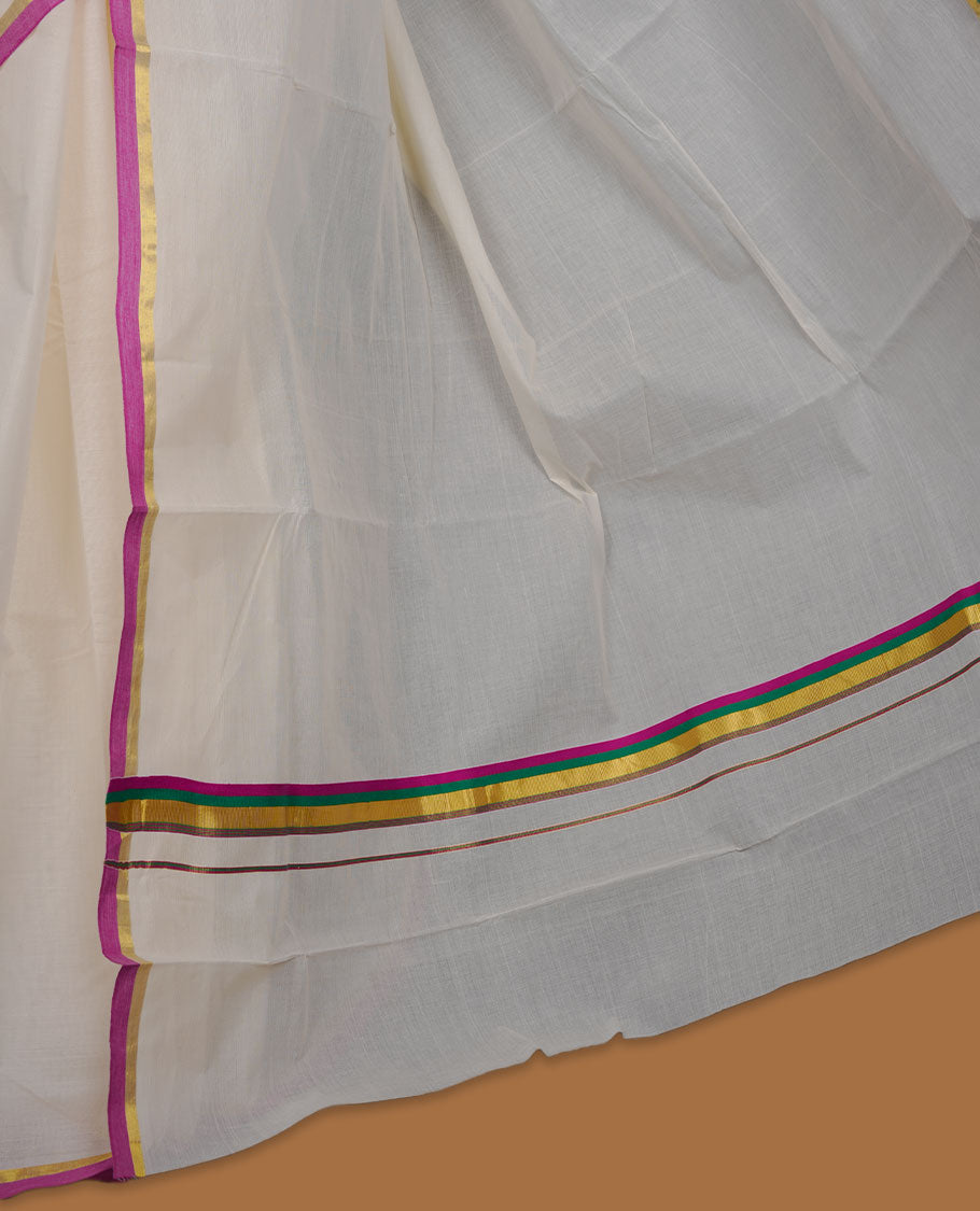 Off-white colour cotton Kerala saree, featuring a classic gold kasavu border highlighted with subtle green and magenta accents, finished with a soft, airy drape and paired with a matching blouse.