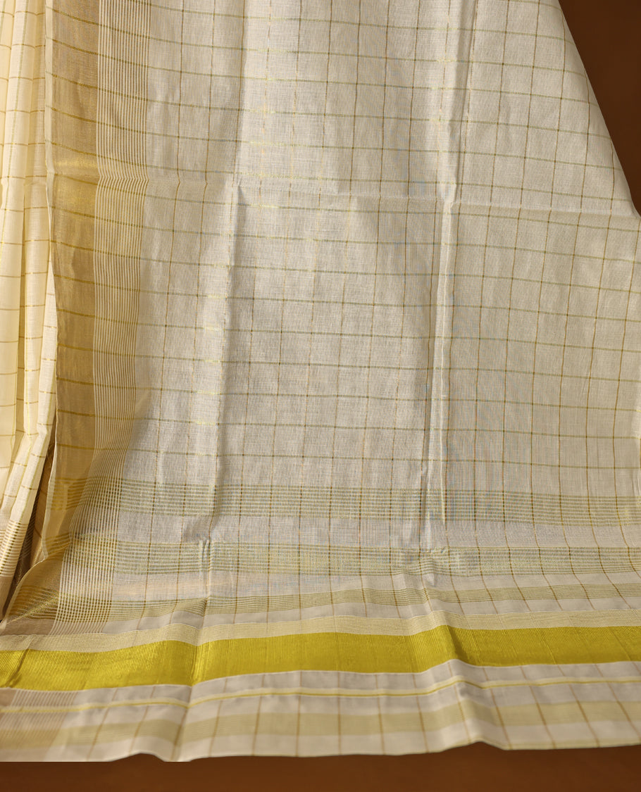 Elegant off white colour cotton Kerala saree with subtle golden and golden checked patterns and a broad golden zari border, Lightweight, breathable, and perfect for traditional events, Includes blouse piece.