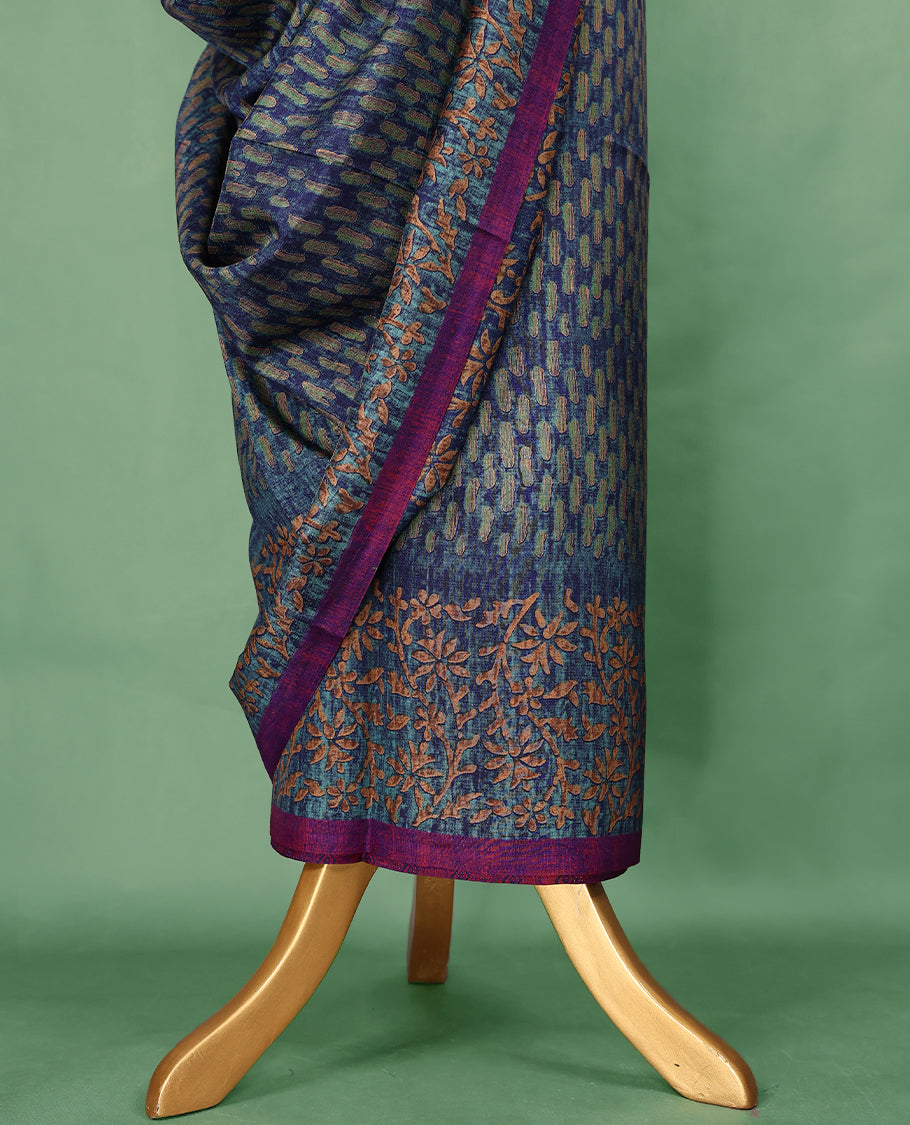 Blue Colour Manipuri saree features a brick patterned body in olive and indigo hues, beautifully offset by a contrasting magenta border with copper floral-printed, and comes with a matching blouse.