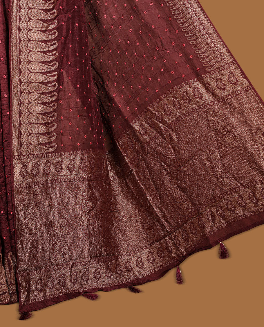 Deep Brown colour Banarasi Bandhani silk saree featuring with intricate orange colour circle motifs on body, complemented by antique zari woven border and grand pallu, paired with matching  blouse