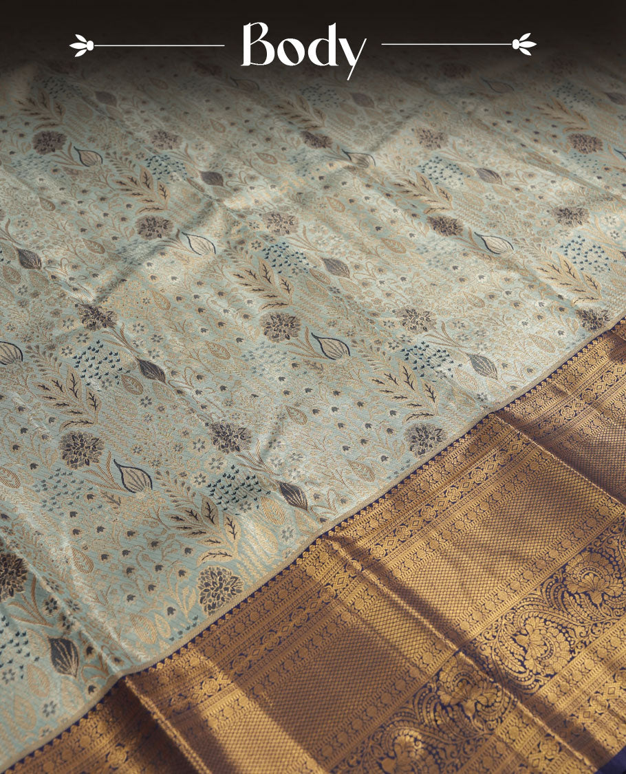 Aqua blue colour and Antique gold Zari Tissue Brocade Saree features intricate floral Motifs on body and navy blue colour border & pallu with traditional patterns paired with matching blouse
