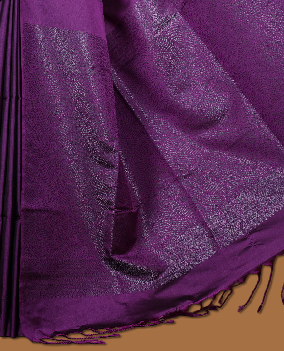 Purple colour semi soft silk saree adorned with delicate woven motifs on the body, complemented by a Self colour woven pallu with intricate detailing and tassel accents without border & Comes with a matching blouse piece.