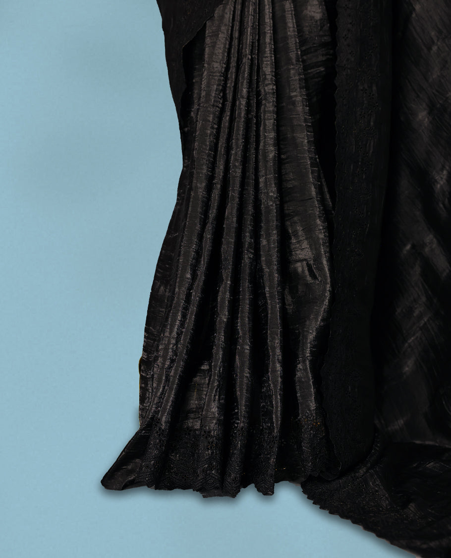 Black Colour crush soft silk saree, textured body with a natural crinkled finish, adorned with intricate self colored floral Motifs  and complemented by a delicate thread embroidery cutwork border, paired with a matching blouse