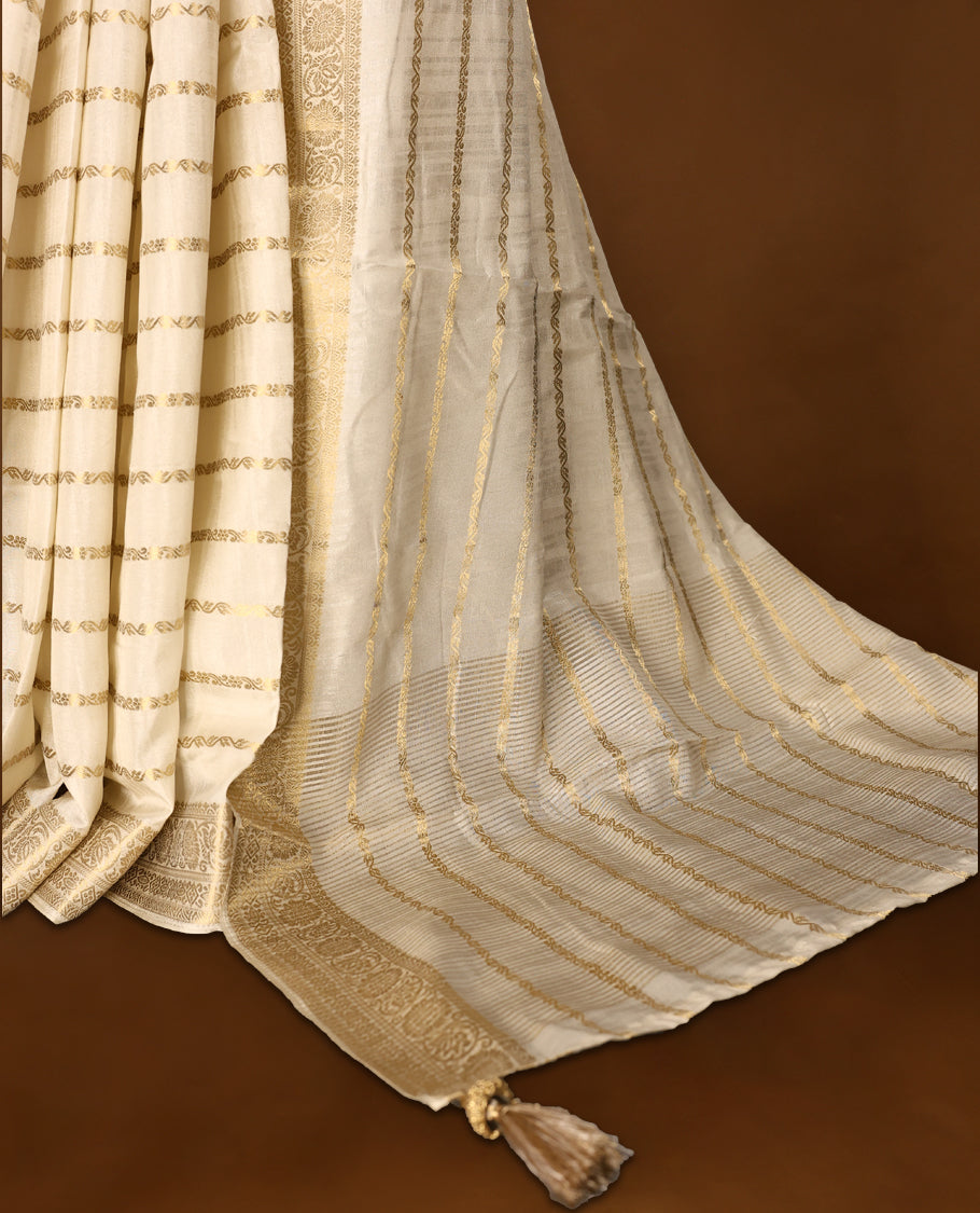 Elegant Off White colour Tussar Kerala saree featuring a Floral Kodi Stripes across body, muted gold zari banarasi Style border, and a striking Gold Zari woven Bold pallu, paired with a matching blouse.