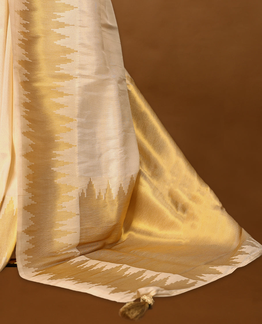 Ivory and gold soft tissue Kerala saree featuring a striking zigzag zari border with a matching blouse