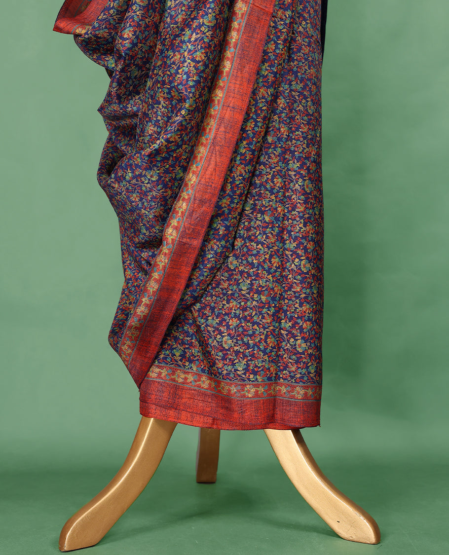 Navy blue colour Manipuri saree adorned with an all over floral pattern in multicolour hues, complemented by a rich rust-red border and matching blouse.
