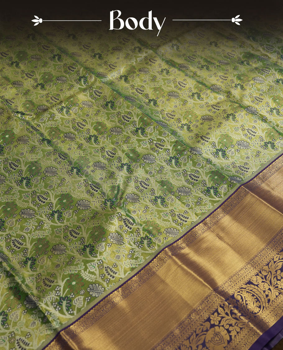 Green colour and Antique gold Zari Tissue Brocade Saree features intricate a coloured floral Motifs on body and rich violet colour with tradiional border & pallu, paired with matching blouse