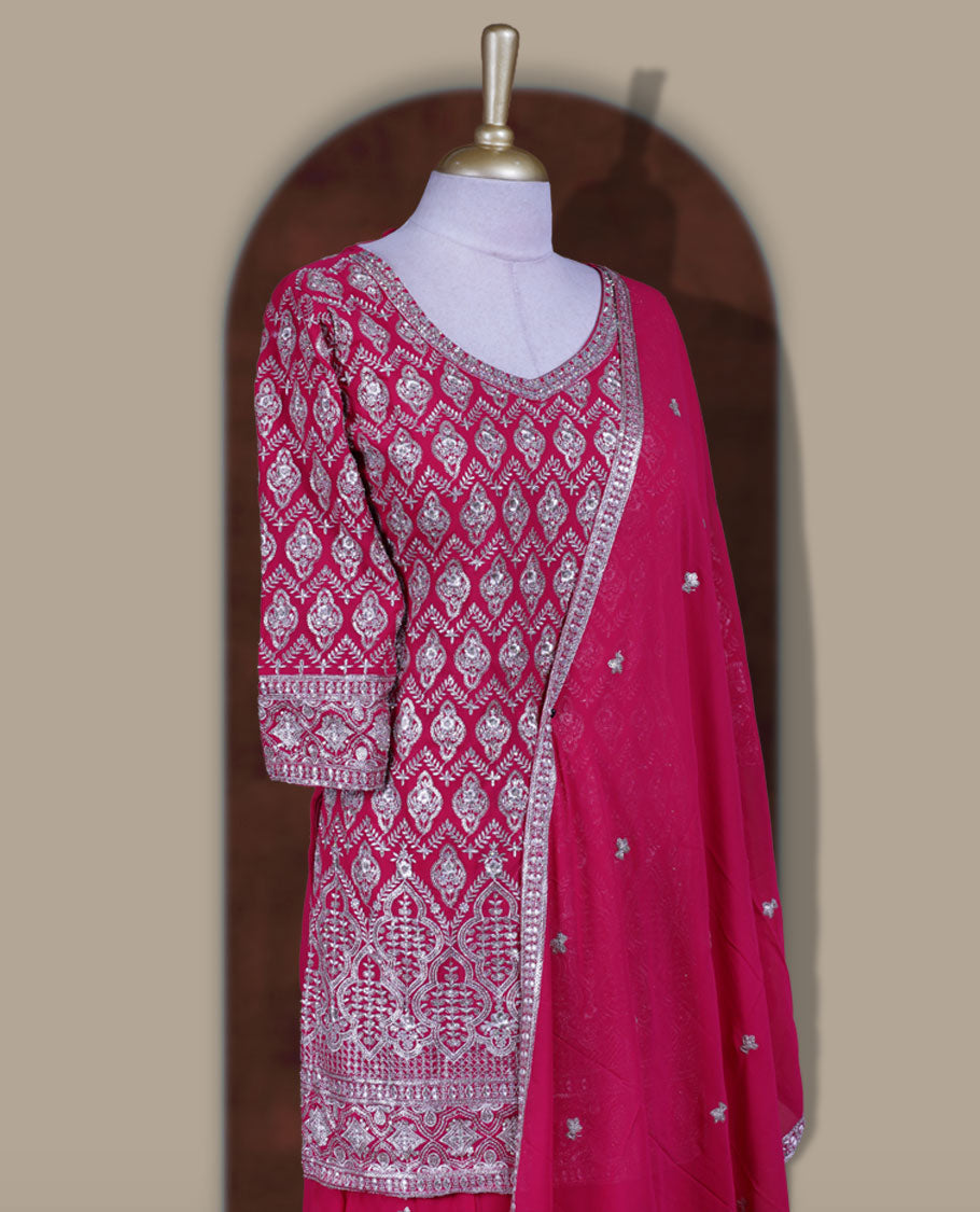 Elegant Magenta colour sharara set featuring a beautifully embroidered top with intricate silver and stone detailing, paired with a flowy flared bottom and a matching dupatta adorned with delicate sequin work.