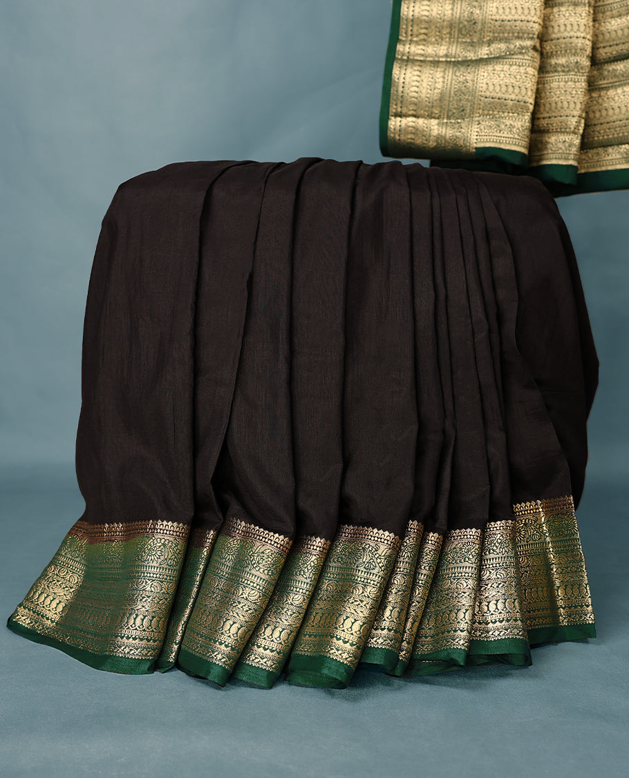 Black colour semi tussar silk saree with plain body, dark green colour traditional border, gold zari work pallu, paired with matching blouse