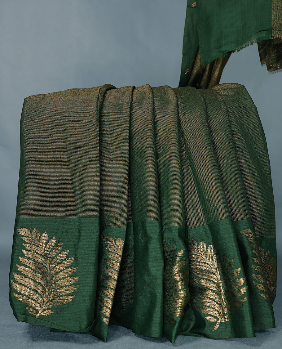 Bottle Green Colour Semi Tussar Silk saree featuring golden zari horizontal lines across the body, adorned with bold Leaf motifs on the border, paired with a matching blouse.