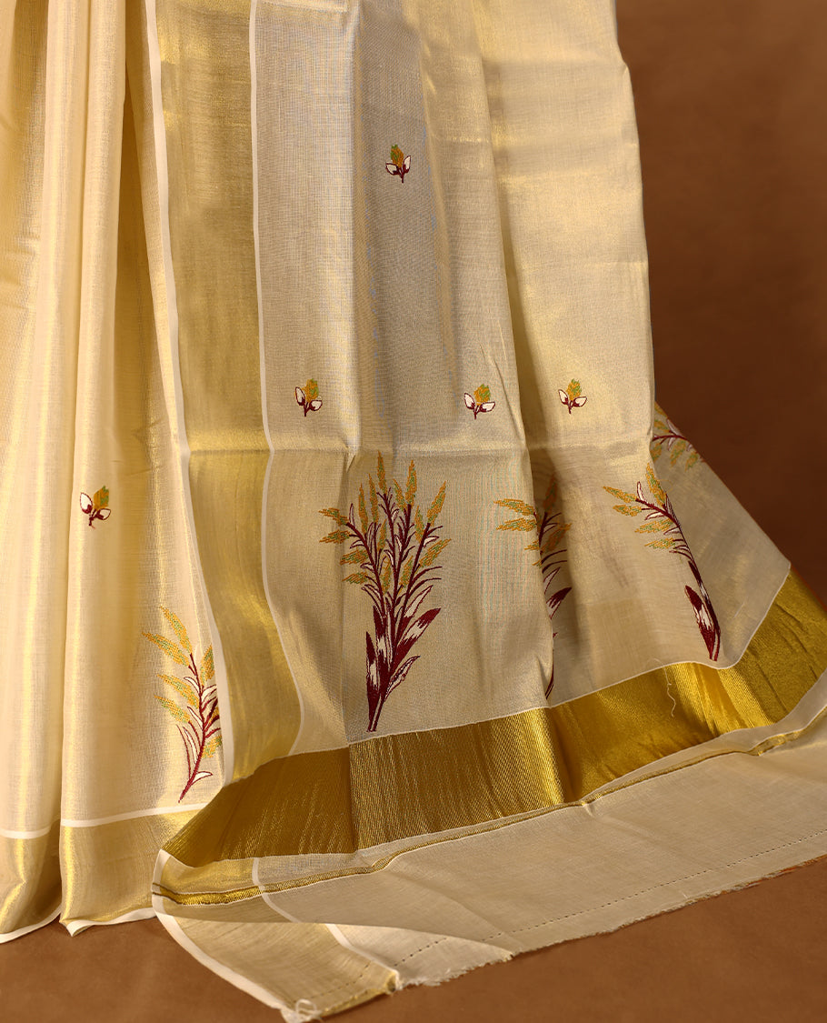 Light Gold colour Tissue Kerala saree featuring nell Kthir embroidery motifs on the body and a beautifully woven Gold Kasavu border, paired with a matching blouse perfect for festive occasions.