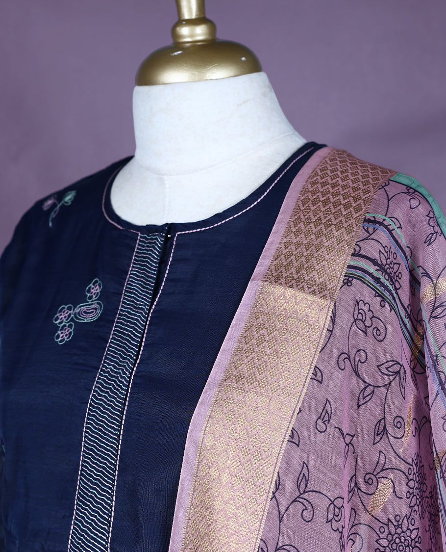 Navy blue Colour kurti set featuring a straight-cut silhouette with 3/4th sleeves, a simple round neckline with a front placket, and delicate floral embroidery, paired with plain Bottam & a richly patterned pastel dupatta with golden detailing.