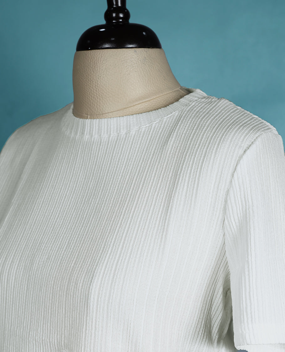 White textured short sleeve top featuring a crew neck and a front ring detail for a subtle, stylish twist.