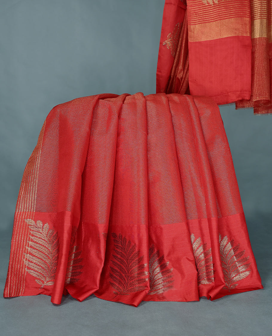 Red Colour Semi Tussar Silk saree featuring golden zari horizontal lines across the body, adorned with bold Leaf motifs on the border, paired with a matching blouse.