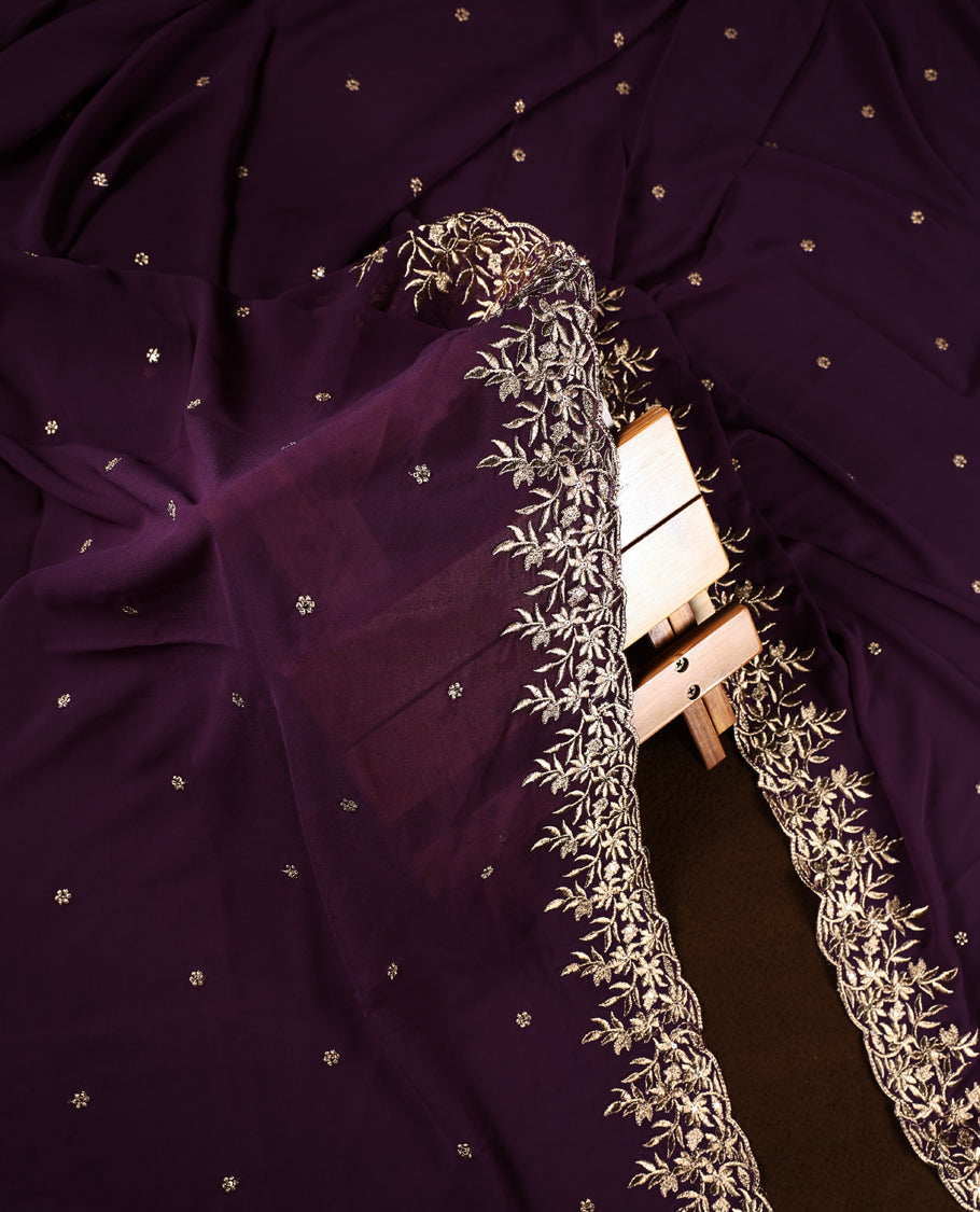 Deep purple churidhar material featuring elegant gold floral embroidery and delicate motifs, paired with a matching embroidered dupatta and plain bottom.