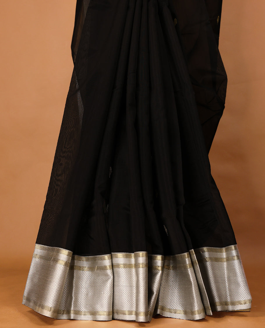 Pure Black coloured Maheshwari Cotton saree featuring  Antique Zari Leaf motifs across the entire body, complemented by a traditional White coloured border and a matching blouse.